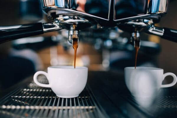 Espresso dripping into cups