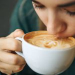 Close up girl is drinking coffee