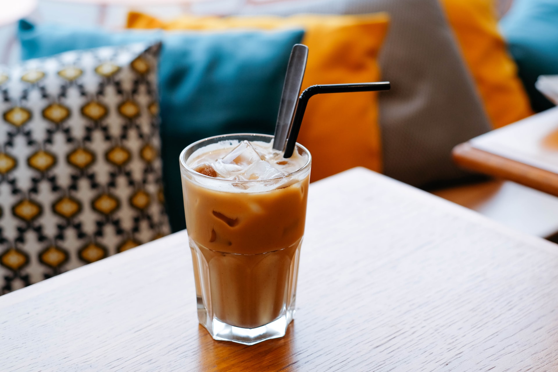 Cup of iced latte with straw  