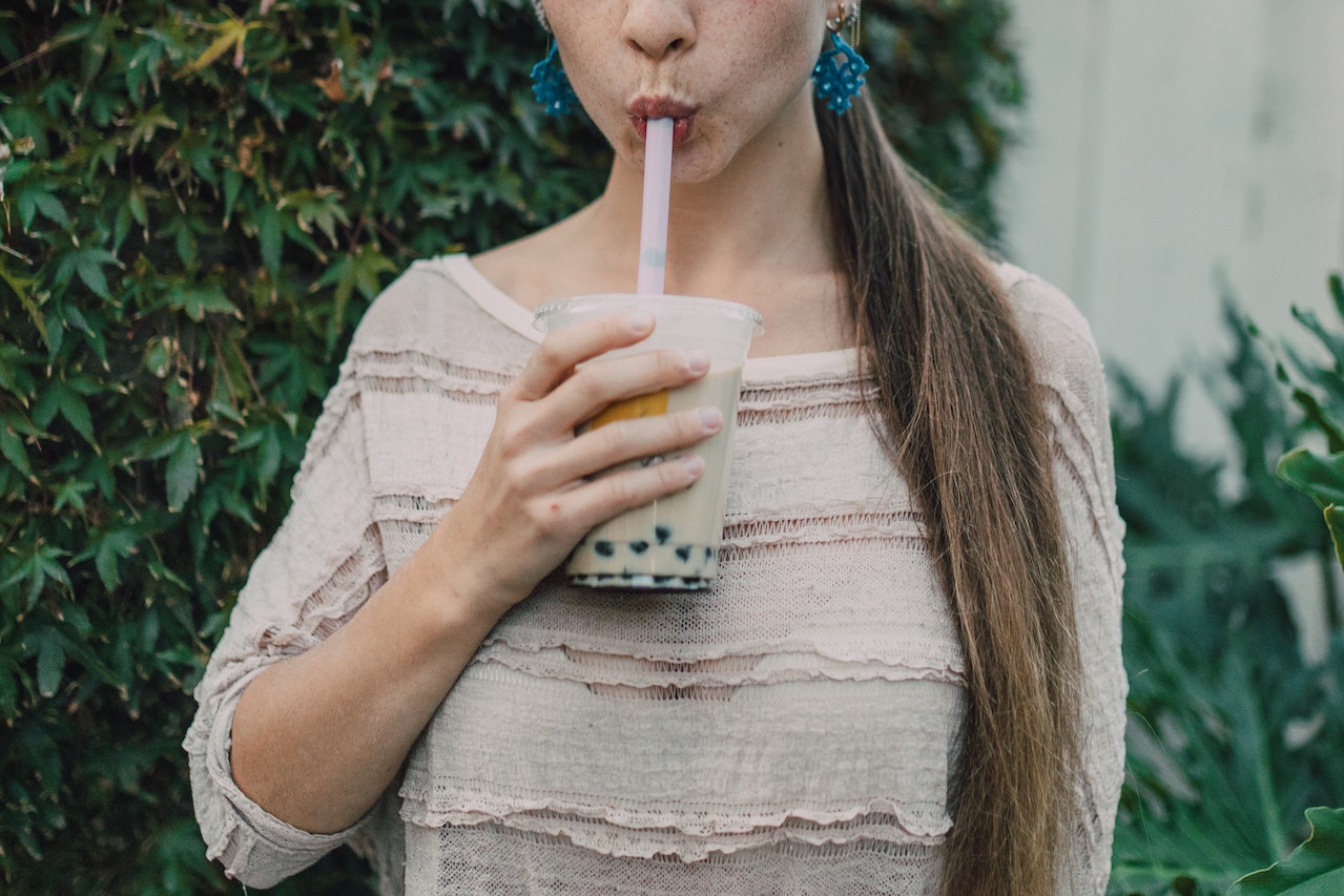 A woman drinking boba tea
