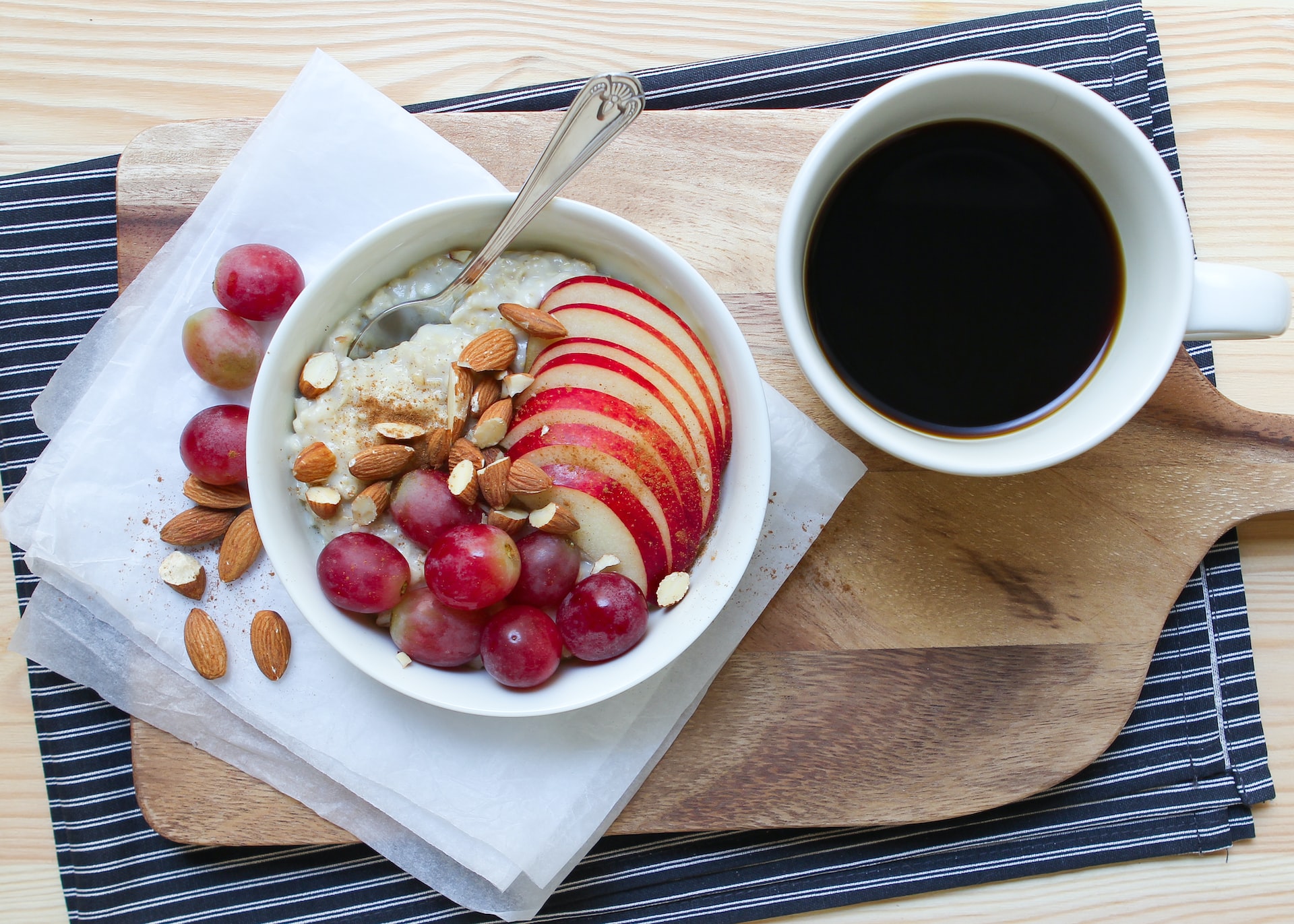 A bowl with apple slices and a cup of coffee