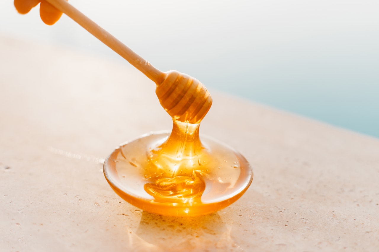 Honey on Plate and Spoon
