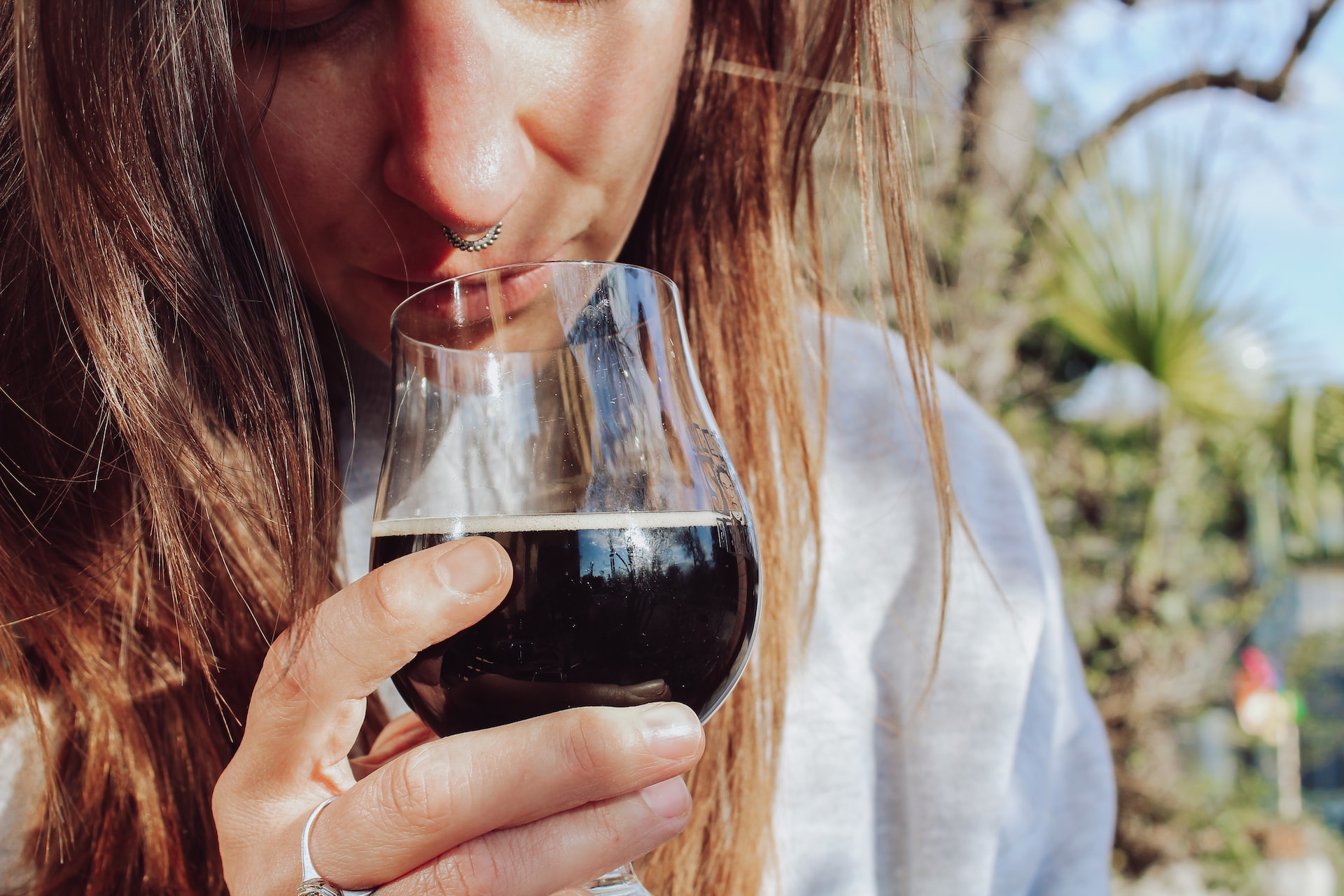 Woman with a glass of dark beer Stout  